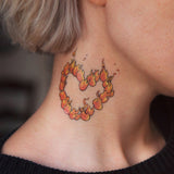 tatuaje corazón en llamas