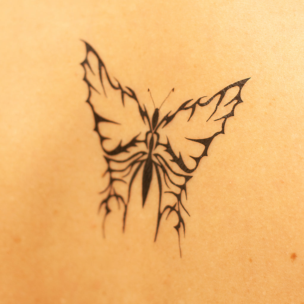 mariposa tribal tatuaje
