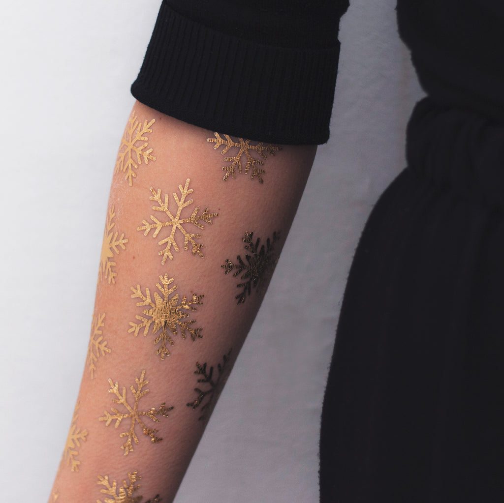 golden snow flakes tattoo